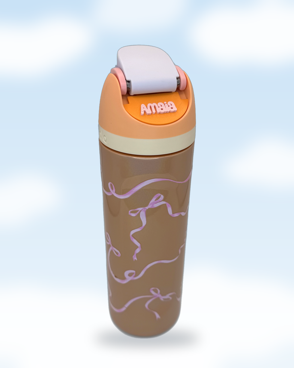 Orange Owala water bottle displaying a personalized Amaia name plate on a pastel cloud background